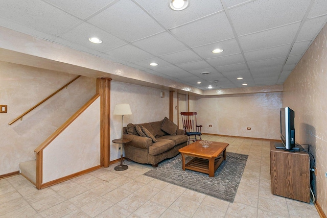 living room featuring stairway, recessed lighting, and a drop ceiling