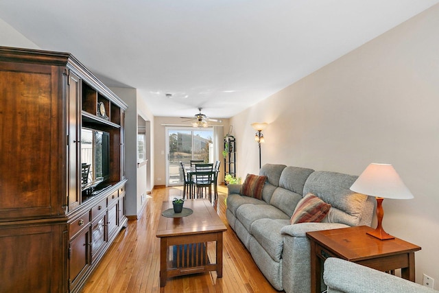 living room with light wood finished floors and a ceiling fan