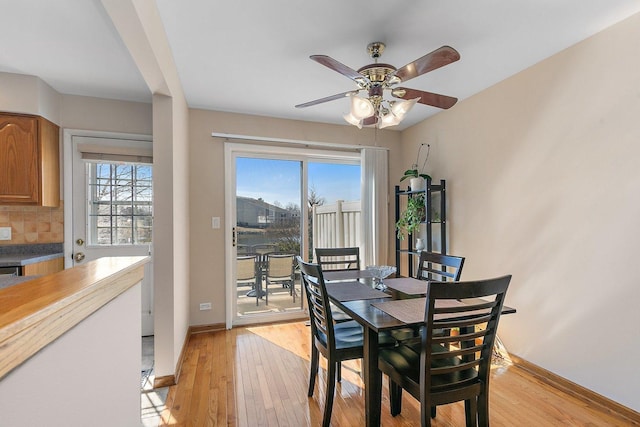 dining space featuring plenty of natural light, light wood-style floors, baseboards, and ceiling fan