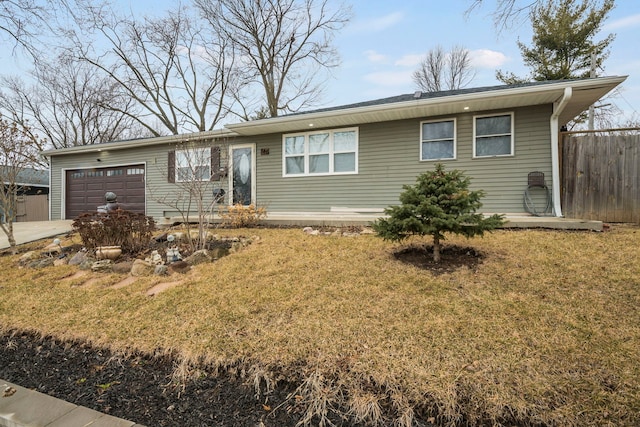 ranch-style house with an attached garage, driveway, fence, and a front yard