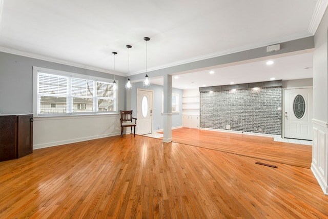 interior space featuring ornamental molding, light wood-type flooring, built in features, and baseboards