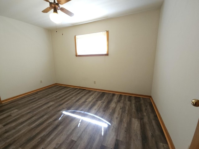 empty room featuring baseboards, ceiling fan, and wood finished floors