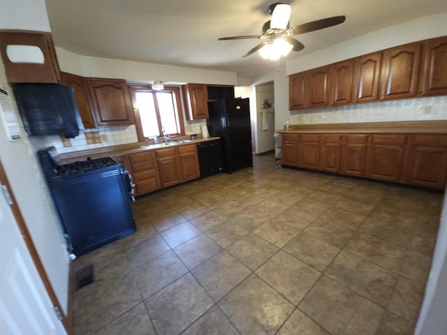 kitchen with ceiling fan, black appliances, brown cabinets, and tasteful backsplash