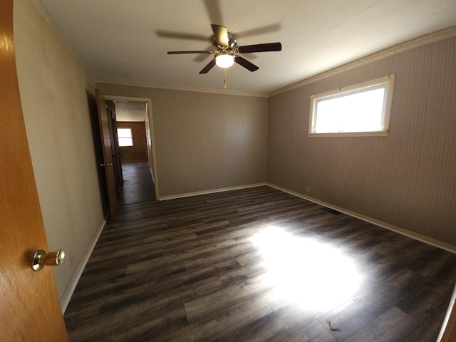 empty room featuring dark wood finished floors, baseboards, plenty of natural light, and ceiling fan
