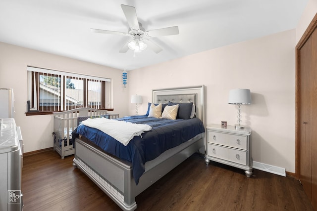 bedroom featuring visible vents, baseboards, ceiling fan, and wood finished floors