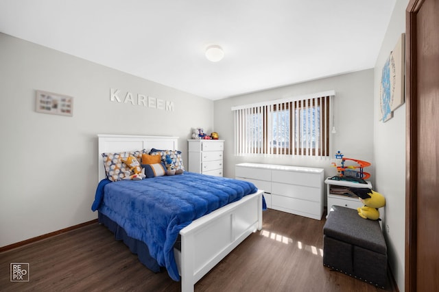 bedroom with dark wood-style floors and baseboards