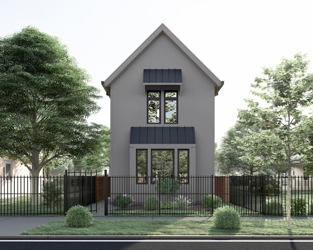 modern farmhouse featuring a standing seam roof, fence, and metal roof