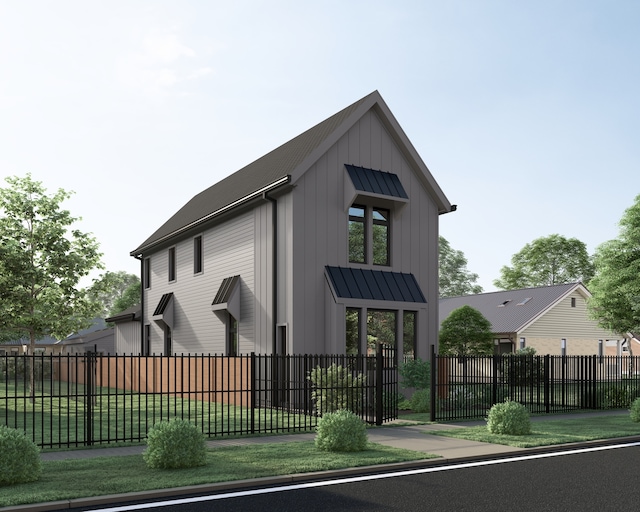 modern farmhouse style home featuring a standing seam roof, a fenced front yard, and board and batten siding