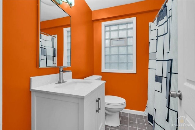 full bath featuring toilet, tile patterned flooring, vanity, and baseboards