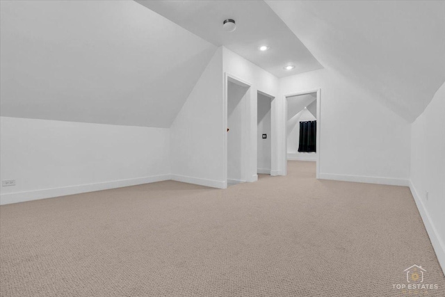 bonus room with lofted ceiling, light carpet, baseboards, and recessed lighting