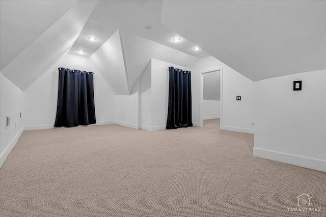 bonus room featuring recessed lighting, light colored carpet, vaulted ceiling, and baseboards