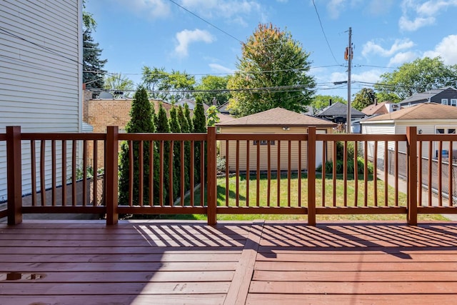 wooden deck featuring a lawn