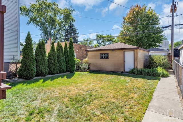 view of yard featuring fence and an outdoor structure