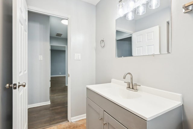 bathroom featuring vanity, visible vents, and baseboards