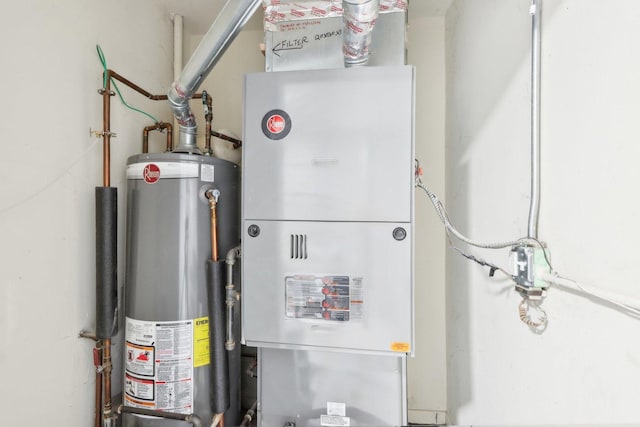 utility room featuring water heater and heating unit