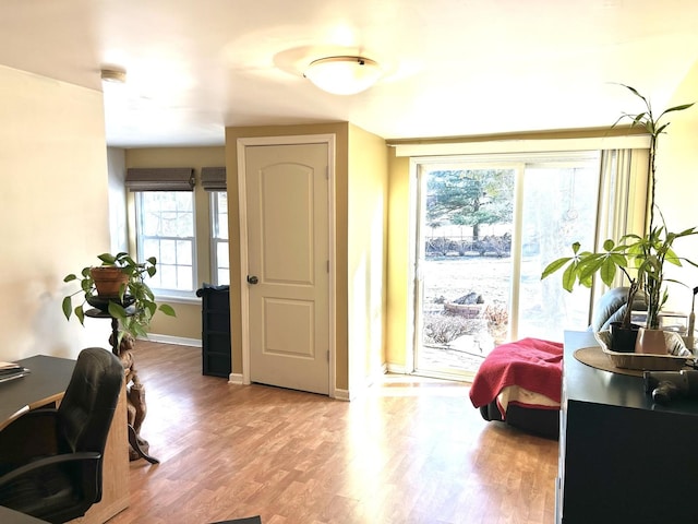 interior space with light wood-type flooring and baseboards