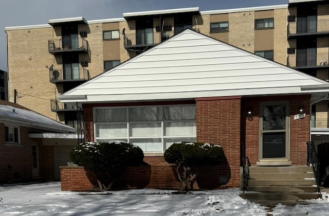 view of front of house featuring entry steps and brick siding