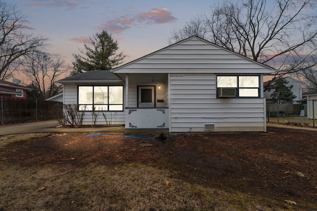 view of front of home with cooling unit, crawl space, and fence