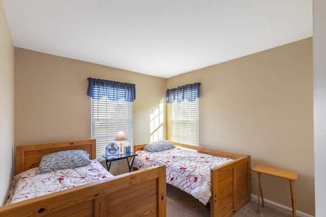 carpeted bedroom featuring baseboards