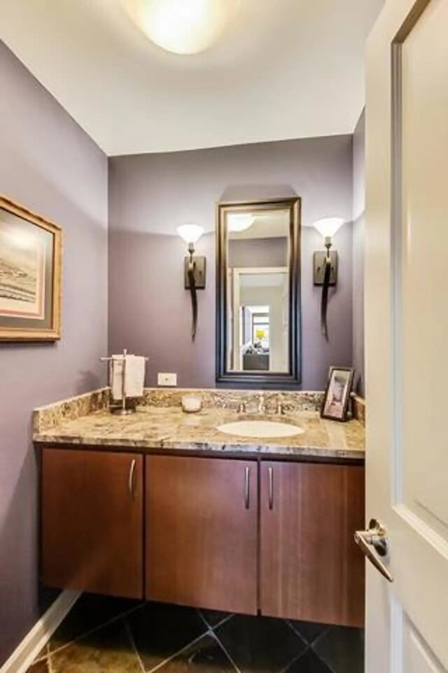 bathroom with vanity, tile patterned floors, and baseboards