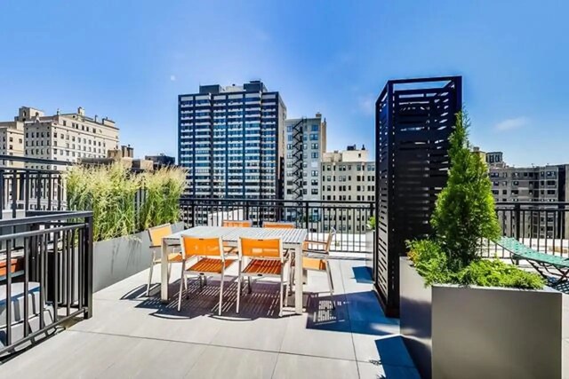 view of patio / terrace featuring a view of city and outdoor dining space