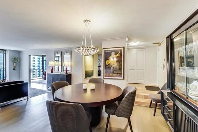 dining area featuring a chandelier and light wood-style flooring