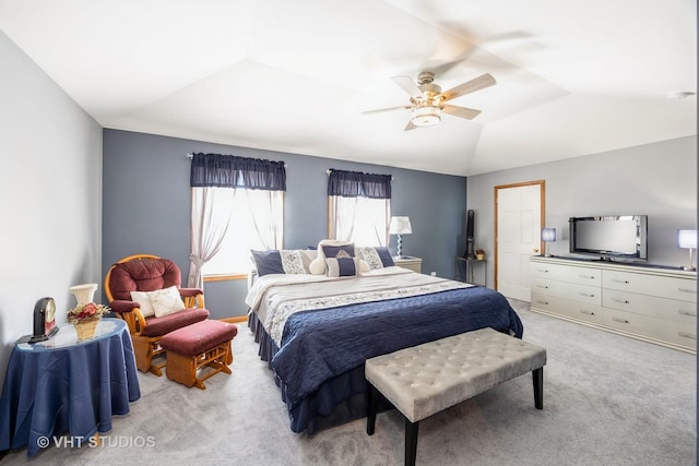 bedroom with lofted ceiling, light colored carpet, and ceiling fan