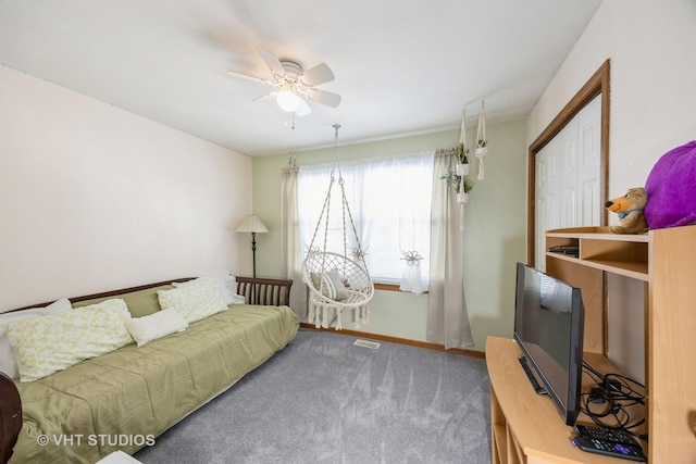 carpeted living room with baseboards and ceiling fan