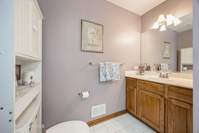 bathroom with tile patterned floors, visible vents, toilet, baseboards, and vanity