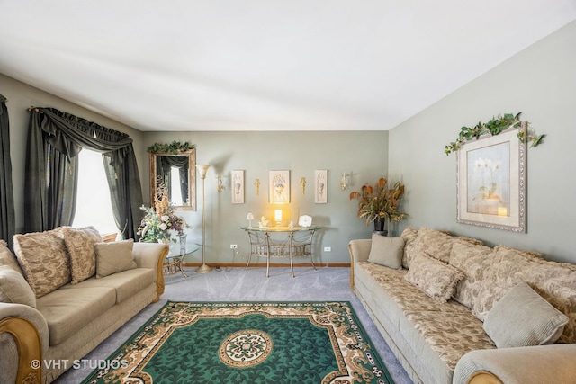 living area featuring carpet flooring and baseboards