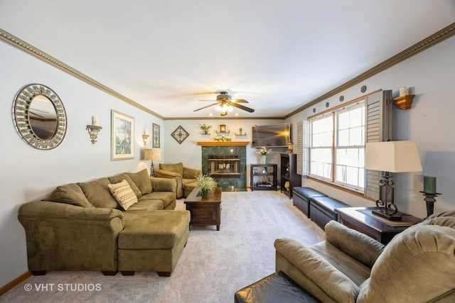 living room with a tiled fireplace, crown molding, and carpet floors