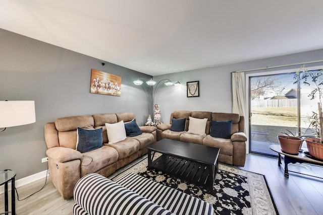 living area with baseboards and light wood-style floors