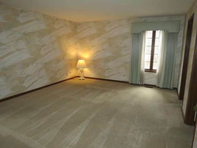 carpeted spare room with visible vents