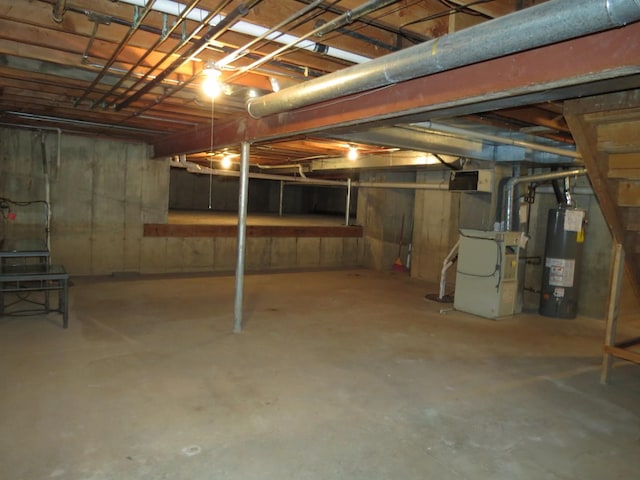 unfinished basement with water heater and heating unit