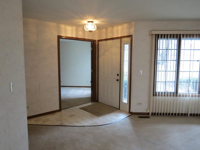 entrance foyer featuring carpet and visible vents