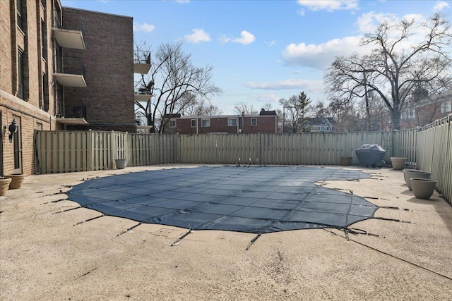 view of swimming pool with a fenced in pool, a patio area, and fence