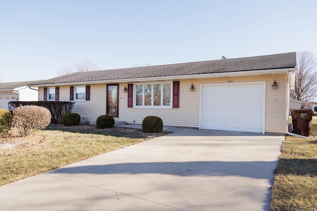 ranch-style house featuring an attached garage, roof with shingles, concrete driveway, and a front yard