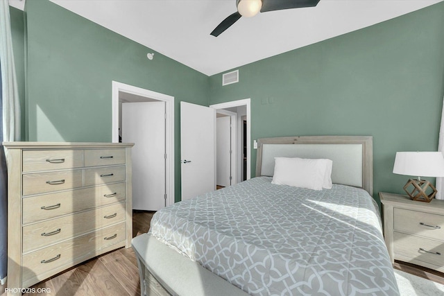 bedroom featuring wood finished floors, visible vents, and ceiling fan