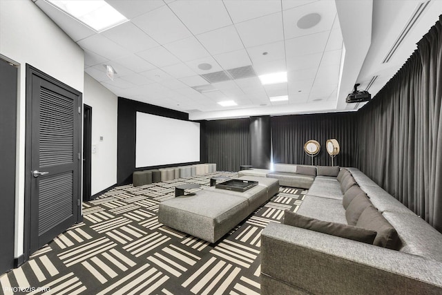 cinema room featuring a drop ceiling and carpet