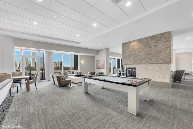 recreation room with recessed lighting, a view of city, and carpet flooring