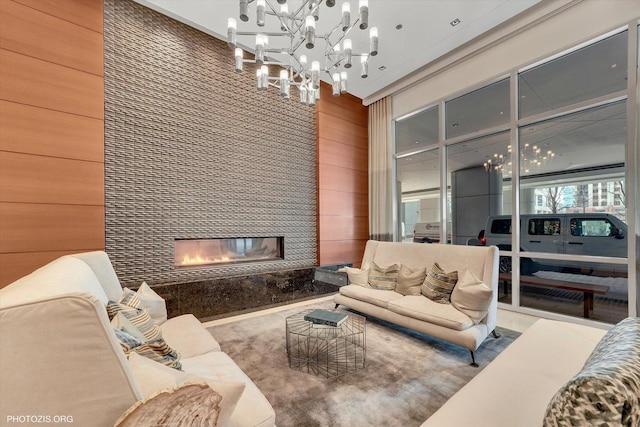 living room featuring wooden walls and a tile fireplace