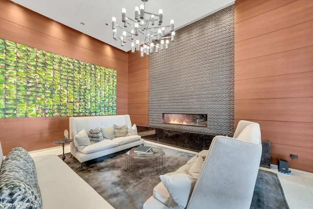 living area featuring wood walls and a tile fireplace