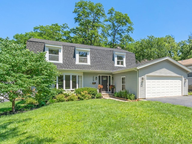 view of front of house with aphalt driveway, roof with shingles, an attached garage, and a front lawn