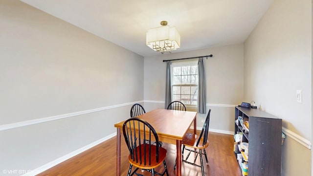 dining room featuring baseboards and wood finished floors