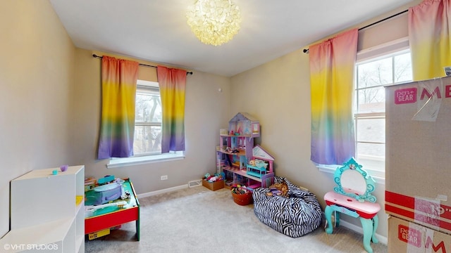 game room featuring an inviting chandelier, plenty of natural light, baseboards, and carpet flooring