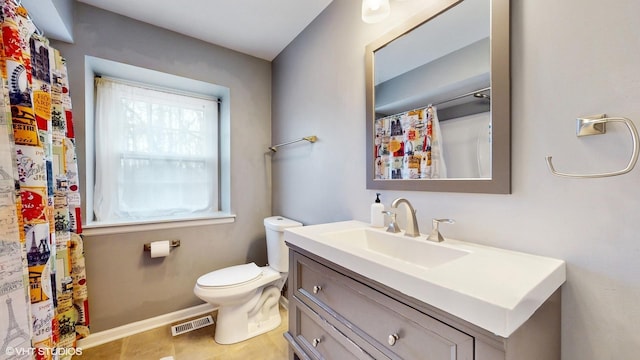 bathroom with toilet, vanity, visible vents, baseboards, and tile patterned floors