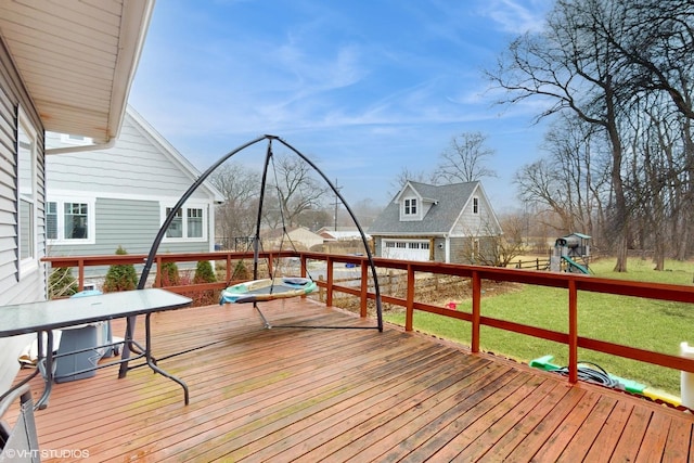 wooden terrace featuring a yard, a playground, and an outdoor structure