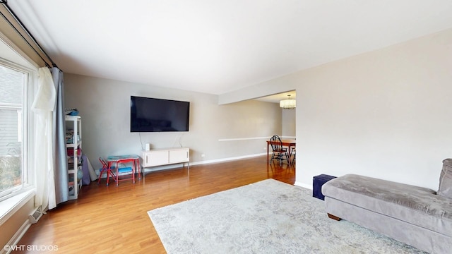 living room with light wood-type flooring and baseboards