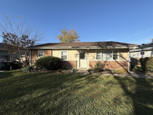 view of front of home featuring a front yard and brick siding