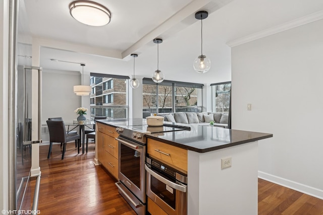 kitchen featuring stainless steel appliances, dark countertops, dark wood finished floors, and ornamental molding